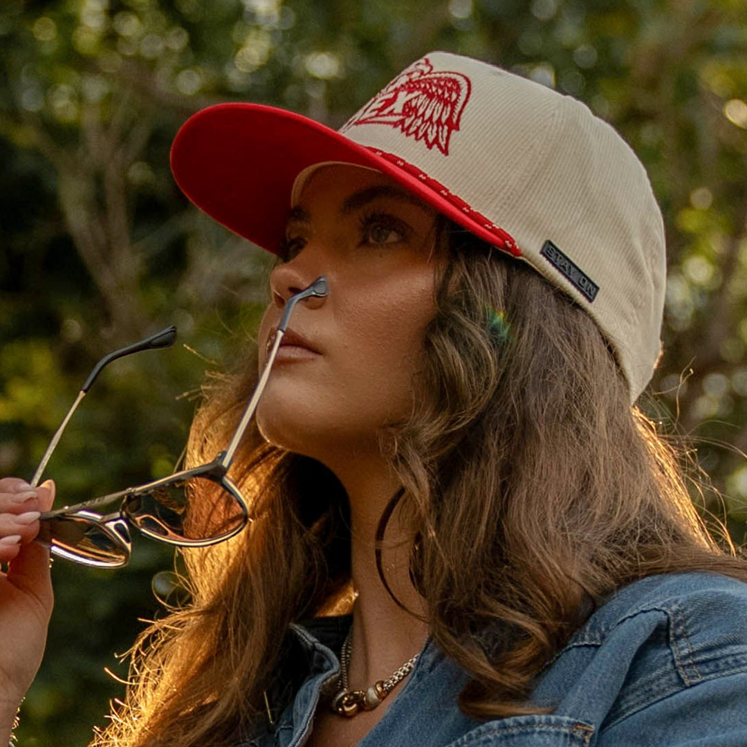 Woman wearing red and bone corduroy trucker cap #color_red