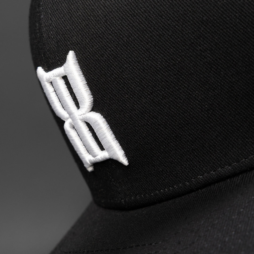 Close-up of the embroidered 3D BEX® logo on the crown of a Steel Black cap #color_black