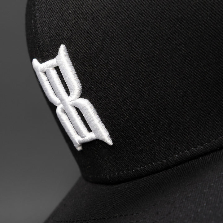 Close-up of the embroidered 3D BEX® logo on the crown of a Steel Black cap #color_black